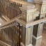 A staircase featuring custom white oak balusters and a matching newel post, designed for a classic architectural look.