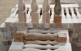 Reproduced wood balusters created to match an original sample, ensuring precise replacement for staircase renovations and repairs.