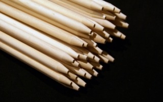 Stack of long birch wood dowels with a blunt point, available in bulk for manufacturers and food-safe applications.