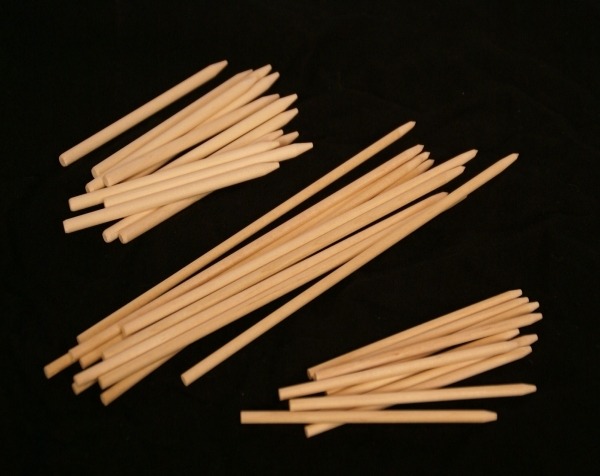 Assorted wooden skewers in different lengths and thicknesses, designed for candy apples, kebabs, and food applications.