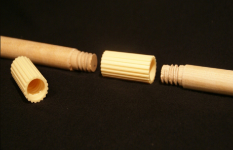 Two dowel handles with threaded ends are screwed together using a plastic connector