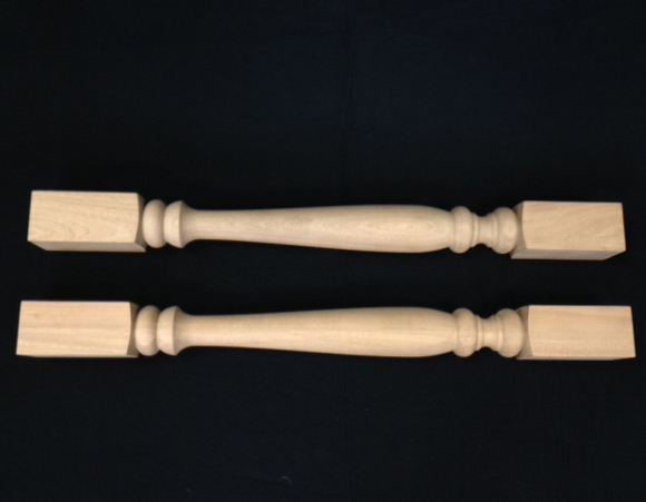 Two wooden balusters turned in middle with square ends made from Mahogany