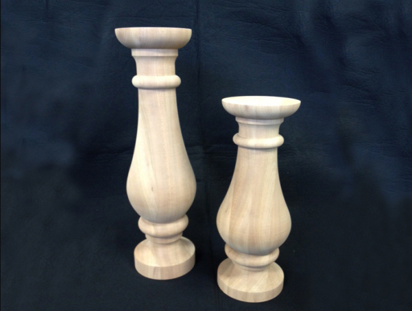 Two large unfinished diameter wooden balusters that have a round top and bottom. Both have the same design, but one is smaller.