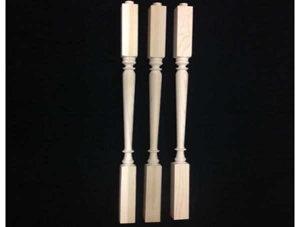 Three wooden balusters, turned in middle, with a square top and bottom.