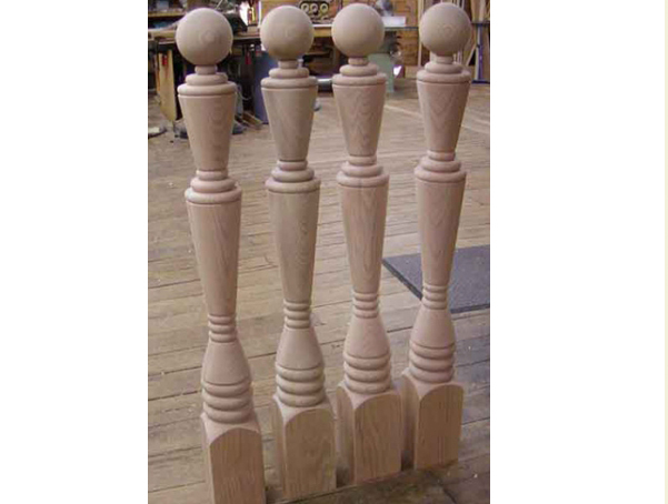 Four turned ball top wood newel posts.