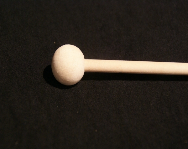 One small diameter wood dowel with a wood cap on one end