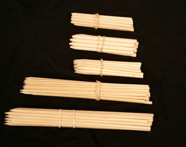 Five bundles of wooden skewers in various sizes, available in bulk for manufacturers and large-scale production.