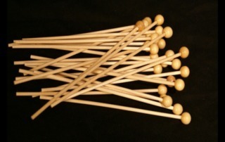 Custom wood dowels with rounded ball tops, suitable for use as food-safe sticks for rock candy, lollipops, and specialty displays.