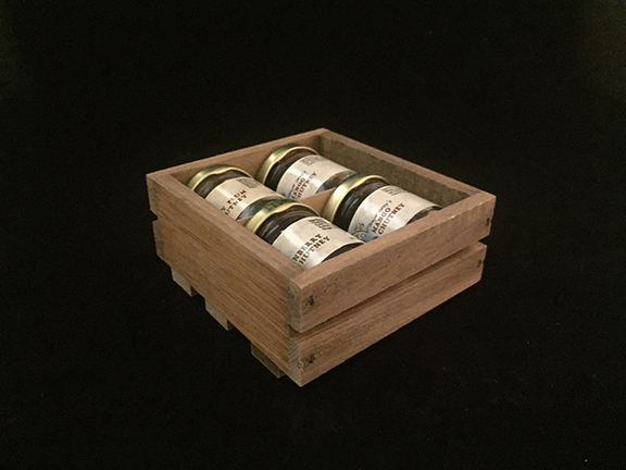 Custom wood crate for packaging gift specialty food items. This photo shows 4 glass small class jars packed in small crate.