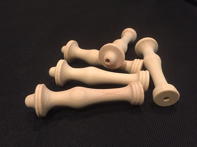 Custom white hard maple wood turnings made into a bunch of rug hook handles.