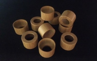 Assorted precision-turned bamboo bottle caps designed for premium packaging in cosmetics, beverages, and specialty products.