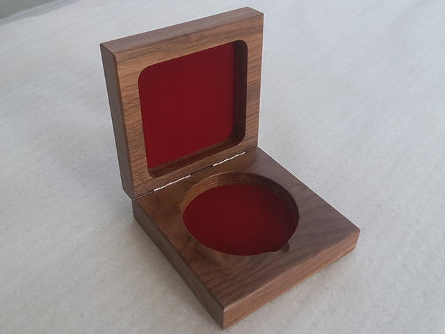 Walnut hinged custom wood box routed both on interior top and bottom to house medallion. Routed sections are lined in red felt and it has a clear satin finish.