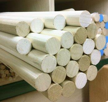 Custom Poplar Dowels for High-Volume Wood Manufacturing Multiple smooth poplar wood dowels stacked for custom bulk manufacturing projects.