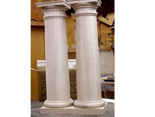 Two soft maple Tuscan wood columns with a capital and base, showcasing custom architectural detailing.