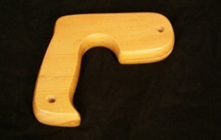 Assorted custom wooden saw handles displayed for bulk and specialty woodworking applications.