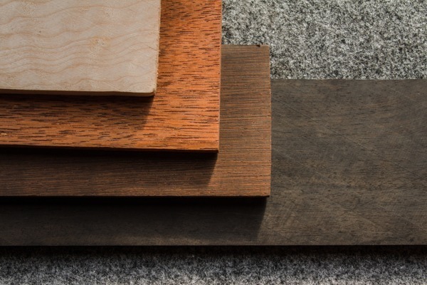 Variety of Wood Species for Custom Manufacturing and Applications Assorted wooden boards showcasing different wood species, displayed on a dark background for visual contrast.