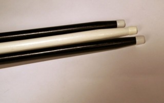Two black wooden canes and one white painted wood cane, available in bulk for manufacturers and high-volume production.