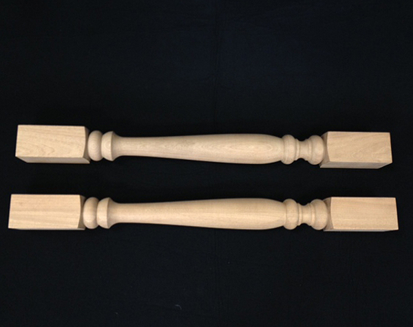 Two wooden balusters turned in middle with square ends made from Mahogany