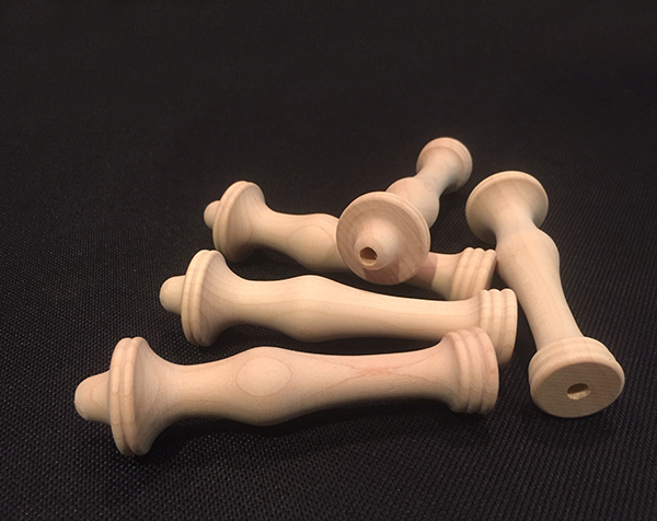 Custom white hard maple wood turnings made into a bunch of rug hook handles.