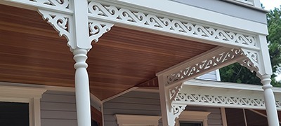 A residential porch featuring custom wood columns installed as part of a recent project.