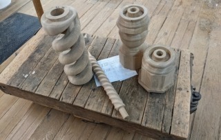 White oak twisted newel post featuring a “twist within a twist” design, unassembled for easy finishing.
