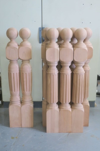 Fluted Sapele Newel Posts – Custom Turned with Ball Cap Fluted Sapele newel posts featuring a ball cap, designed for staircases and architectural millwork.