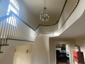 A newly installed staircase featuring custom poplar balusters and a newel post crafted by Arnold Wood.