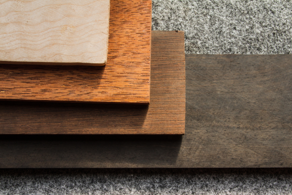 Selection of wooden boards showcasing different wood species used in custom manufacturing.