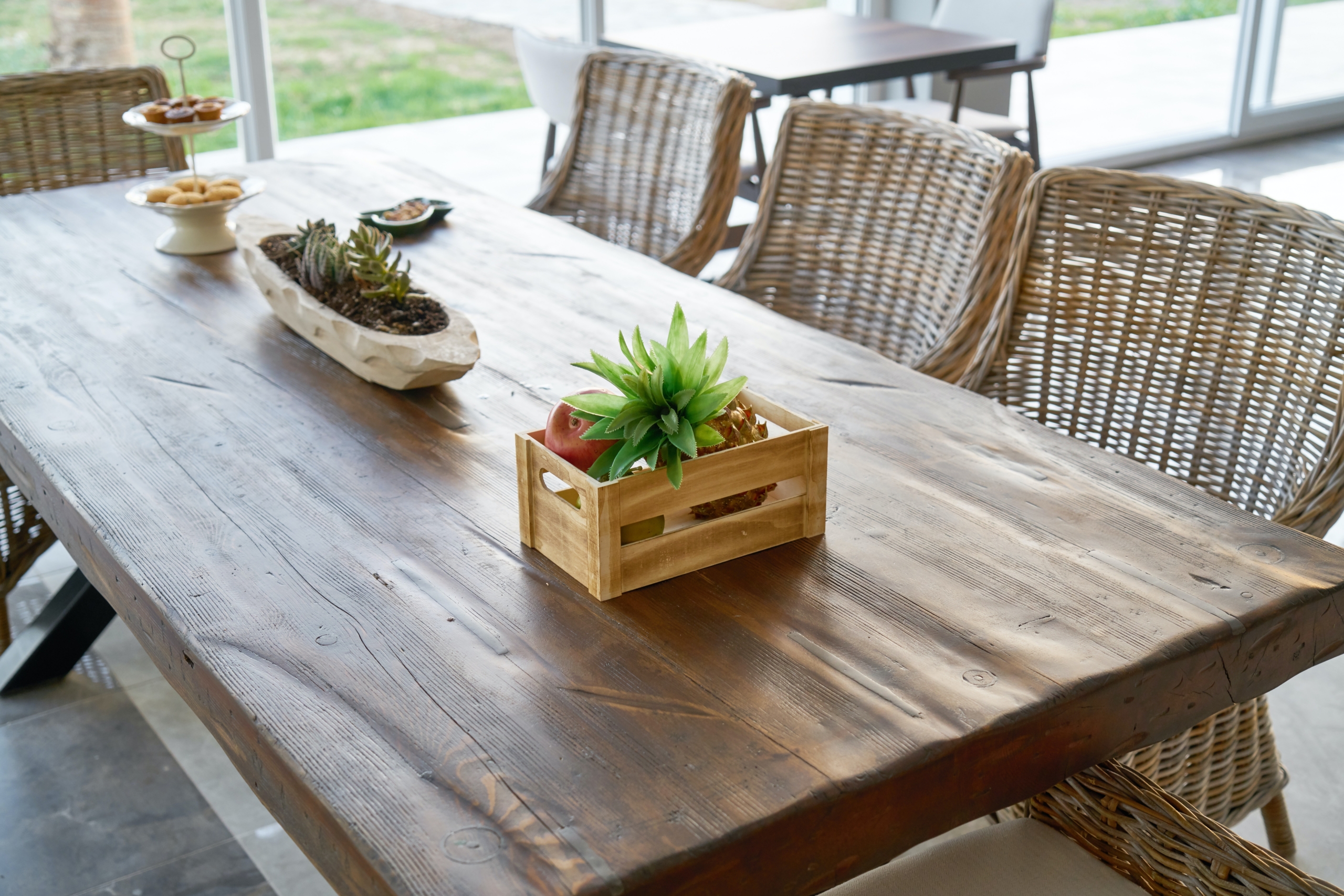 Wood dining table with various centerpieces.