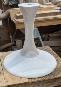 Unfinished wood dining table base designed and crafted for a custom furniture project.