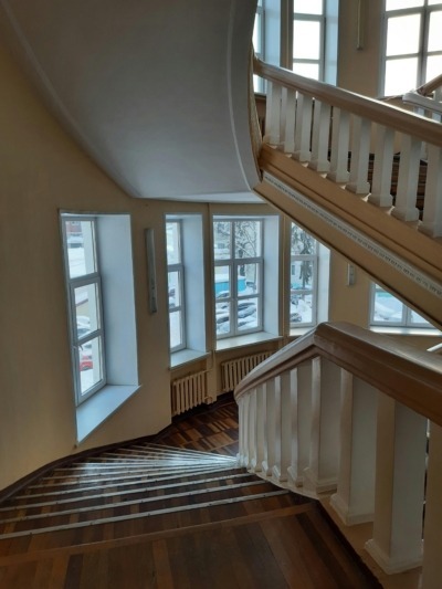 A staircase in a home made up of wood balusters spanning multiple levels.