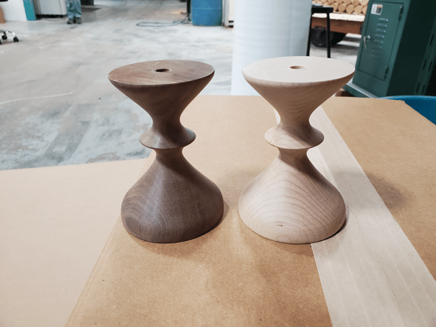 Turned Lamp Bases Turned lamp bases made from laminated walnut and hard maple, precision-machined and drilled for lighting hardware installation at scale.