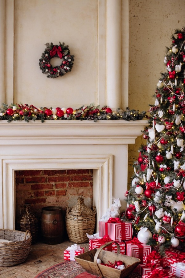 Fireplace Remodel with Mantel and Holiday Decor White fireplace with brick interior, decorated mantel, and Christmas tree.