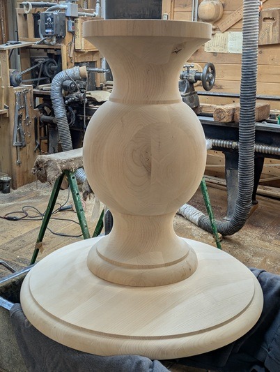 Knotty Alder Pedestal Base Before Finish Unfinished Knotty Alder pedestal base fully assembled in a woodworking shop before staining for use under a kitchen island countertop.