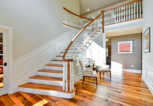 Entryway with Updated Wood Stair Spindles Interior staircase with wood steps and painted wood spindles after spindle replacement.