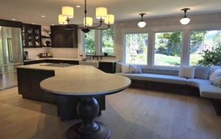 Wide Kitchen View with Pedestal Island Support Wide angle view of a kitchen featuring a custom pedestal base supporting the extended island countertop.