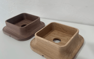 CNC-shaped white oak and walnut lighting canopies for wall or ceiling mounting applications.